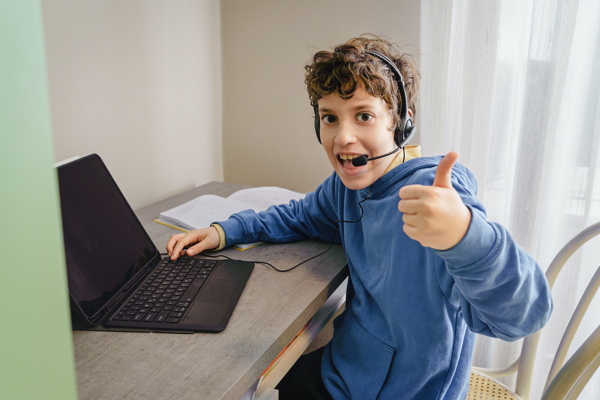 Kid with laptop and headset
